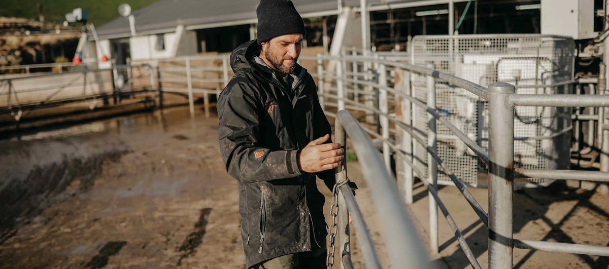 Farmer at the livestock gate in a waterproof jacket