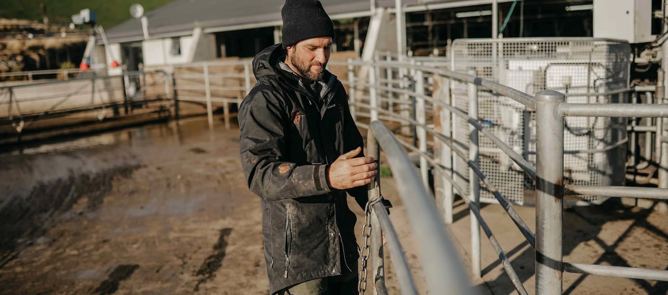 Farmer in a waterproof jacket at the cattle shed