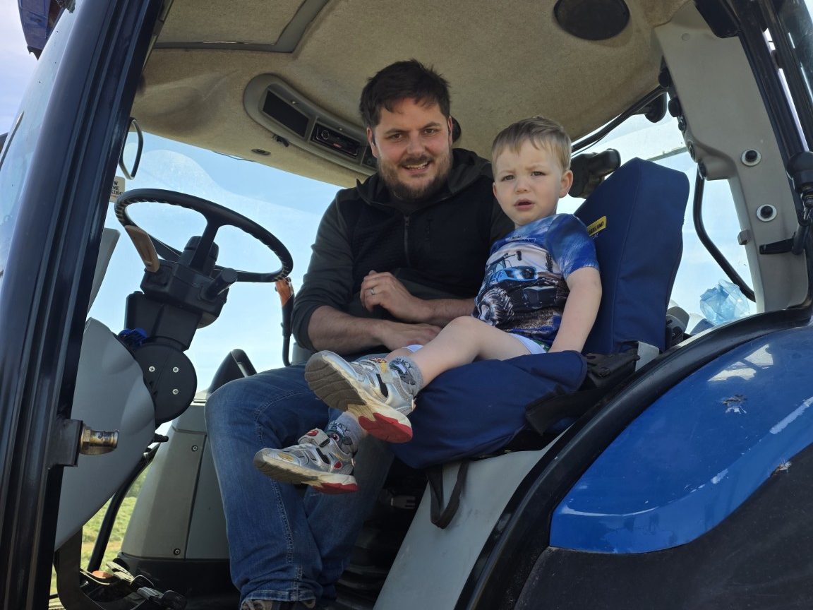 Jason from CFS with his son in the tractor cab