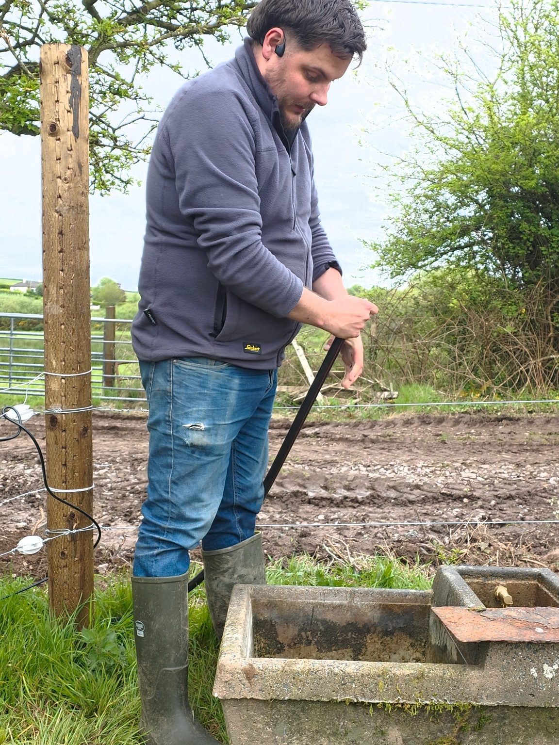 Checking a water trough on the farm